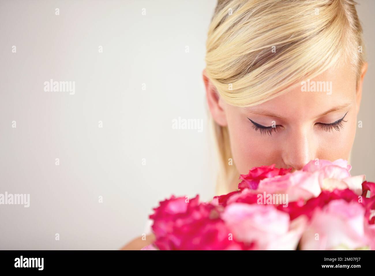 Beautiful blond woman smelling roses hi-res stock photography and ...