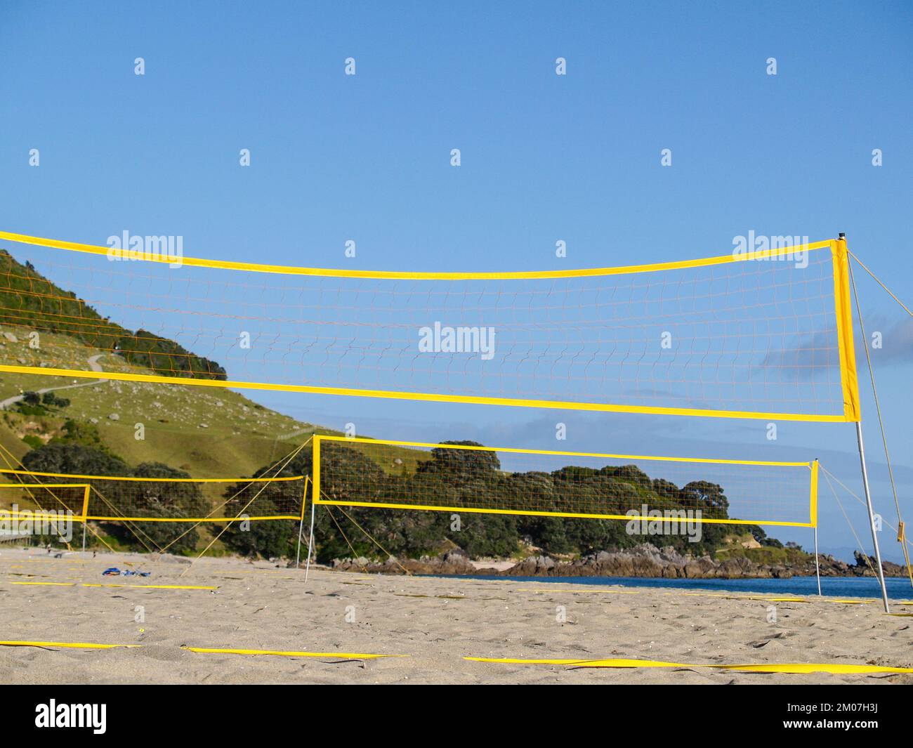 Yellow beach volleyball nets on Mount Maunganui Main Beach, Tauranga