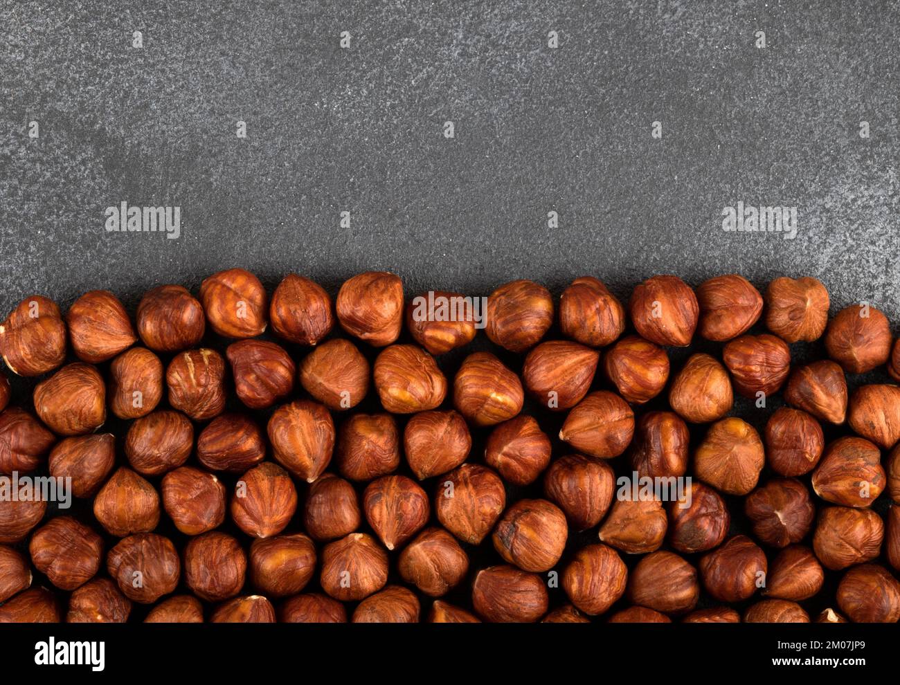 Peeled hazelnuts on black background Stock Photo Alamy