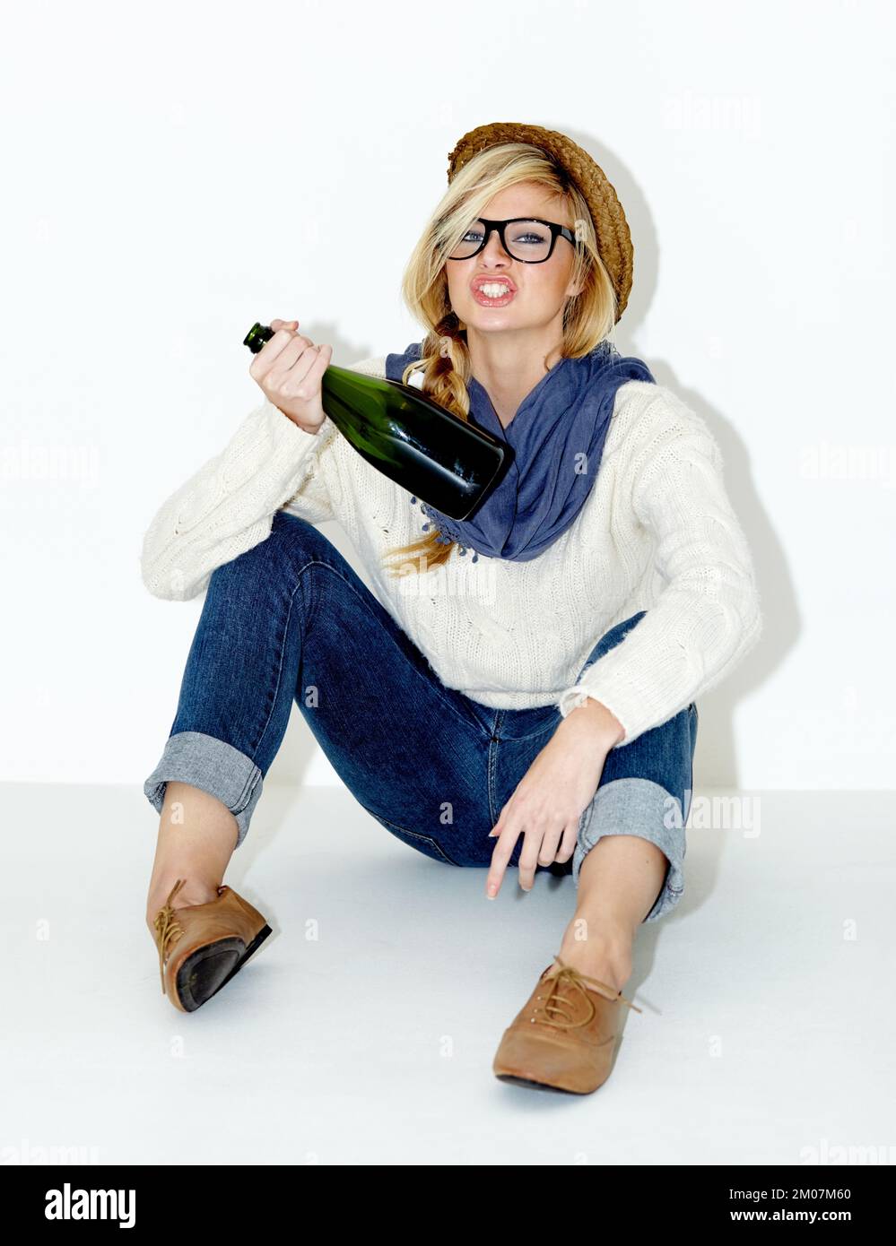 https://c8.alamy.com/comp/2M07M60/young-wild-and-free-full-length-studio-shot-of-a-drunk-young-woman-sitting-with-a-bottle-of-champagne-2M07M60.jpg