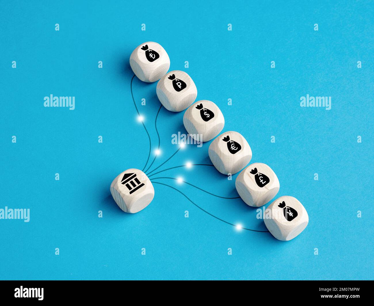 Wooden cubes with bank and currency money bags linked with transfer lines. Currency exchange, electronic fund transfer (EFT), cash, deposit, credit an Stock Photo