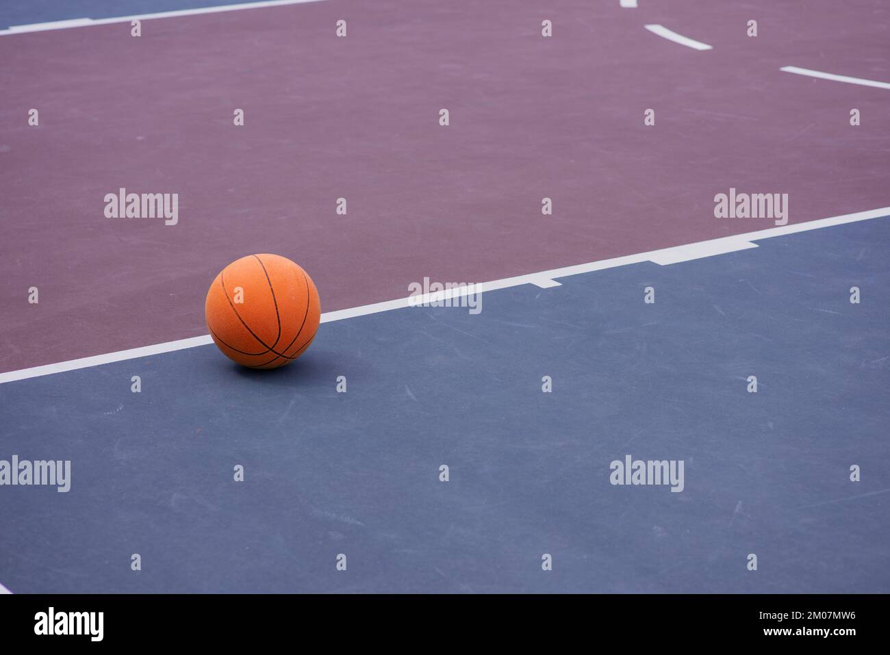 Close up shot of basketball laying on court Stock Photo