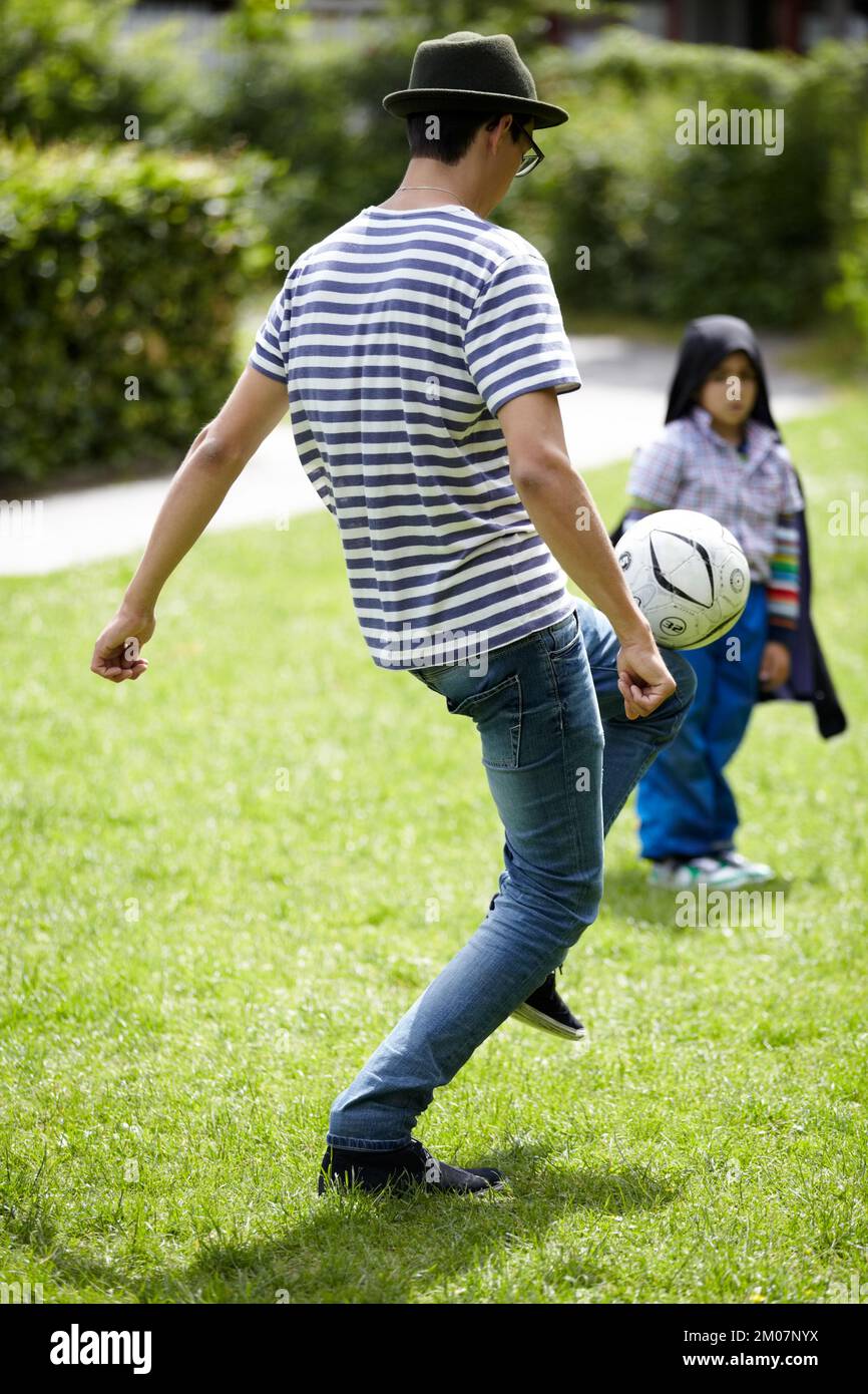 Enjoying a quick game Soccer. Young guy playing football outdoors