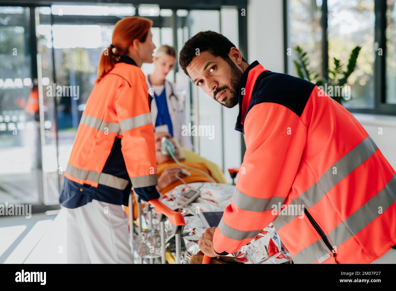 Health Rescuer Rescuers taking care of patient from ambulance Stock Photo - Alamy