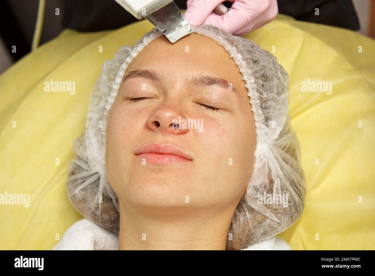 closeup. Ultrasonic face cleaning. Modern equipment. Beautician does