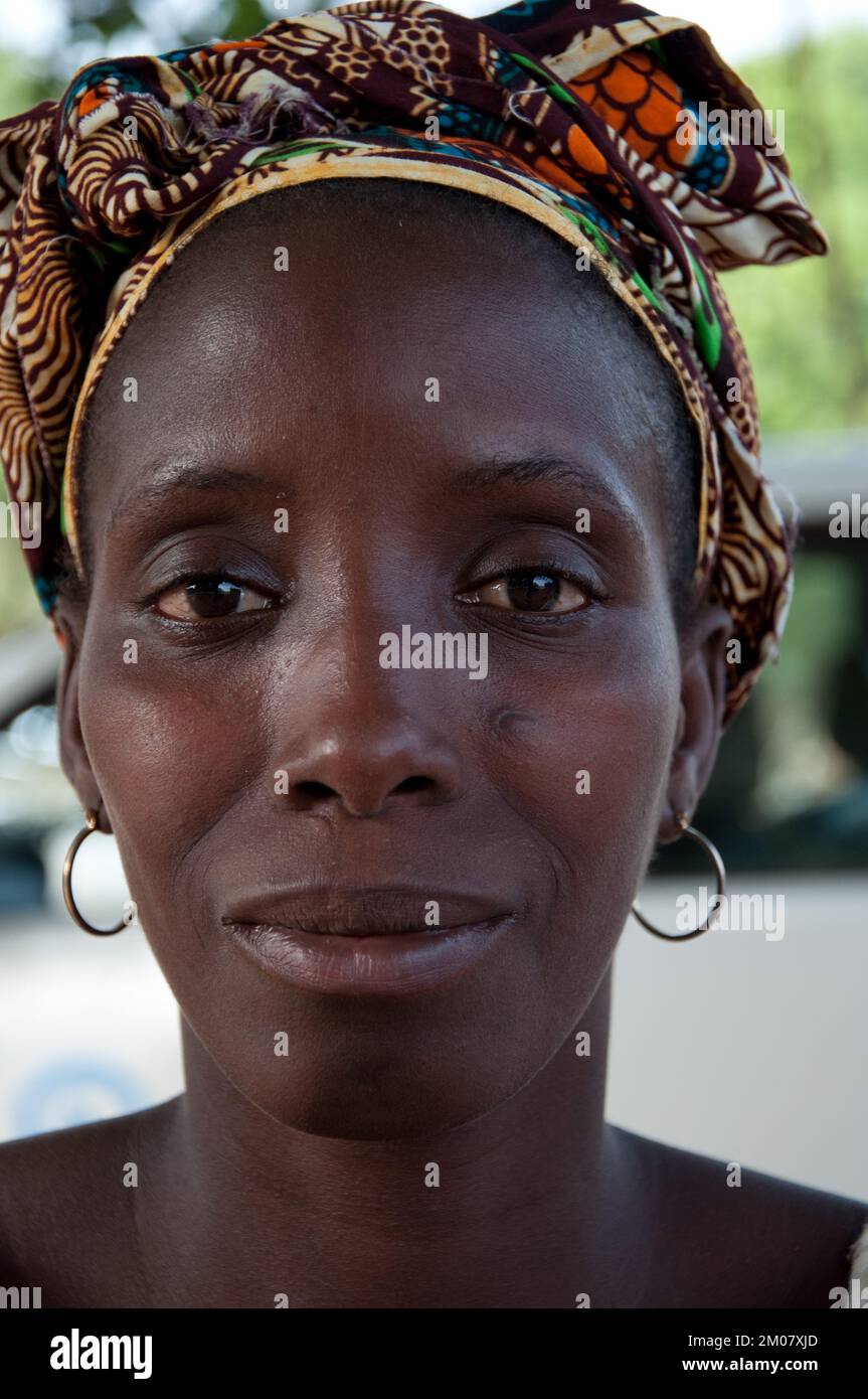 Faces of Africa, African woman, Bafata, Guinea Bissau - woman with subtle smile; lovely head-dress Stock Photo