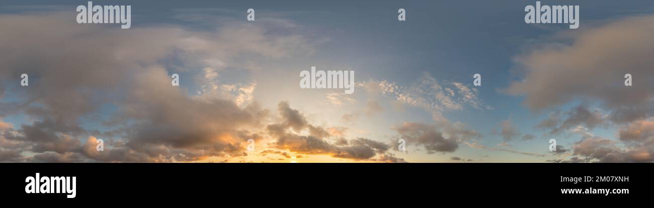 Dark blue sunset sky panorama with golden Cumulus clouds. Seamless hdr 360 panorama in spherical equirectangular format. Full zenith for 3D Stock Photo