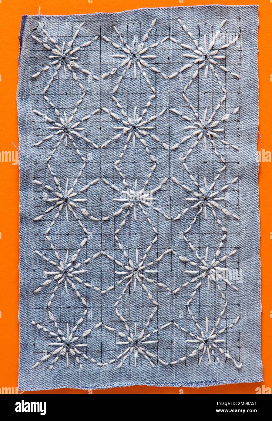 Sashiko embroidery sewing stitch blue fabric. Traditional Japanese sewing pattern call SASHIKO. Learning needlework, teaching how to do, hand work, Japan craft hobby concept. DIY Stock Photo