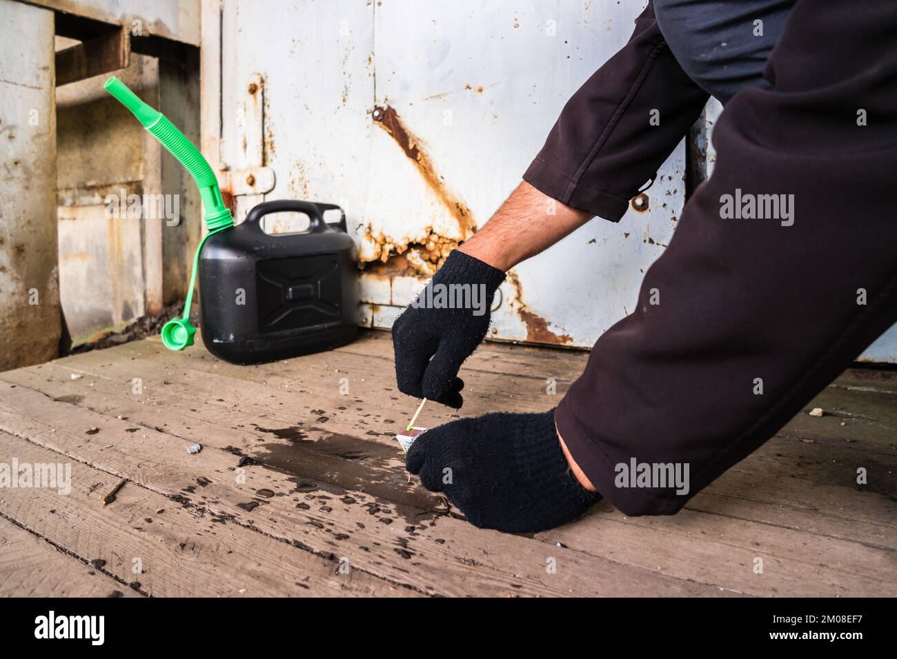 Arsonists symbolically setting fire to a house Stock Photo