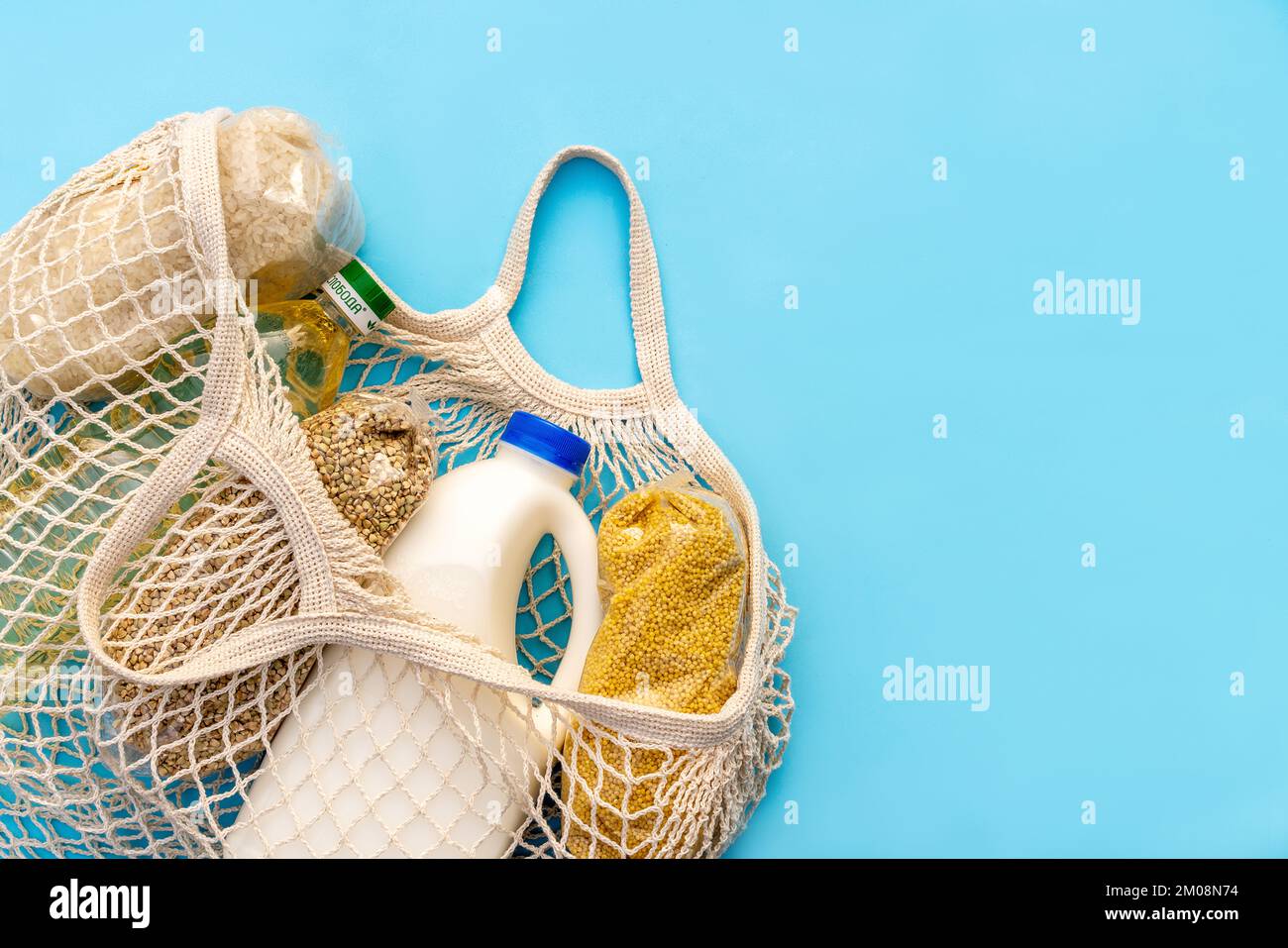 Food supply. Raw porridge, cereals, milk and vegetable oil on the blue