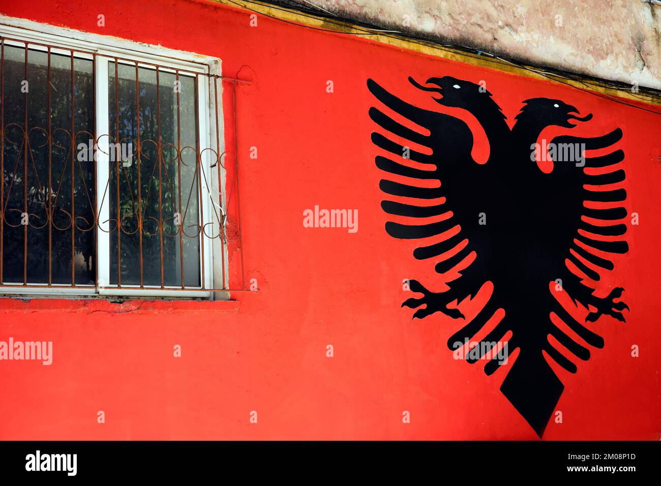 Albanian national coat of arms, double-headed eagle, on a red house wall, Saranda, Albania, Europe Stock Photo