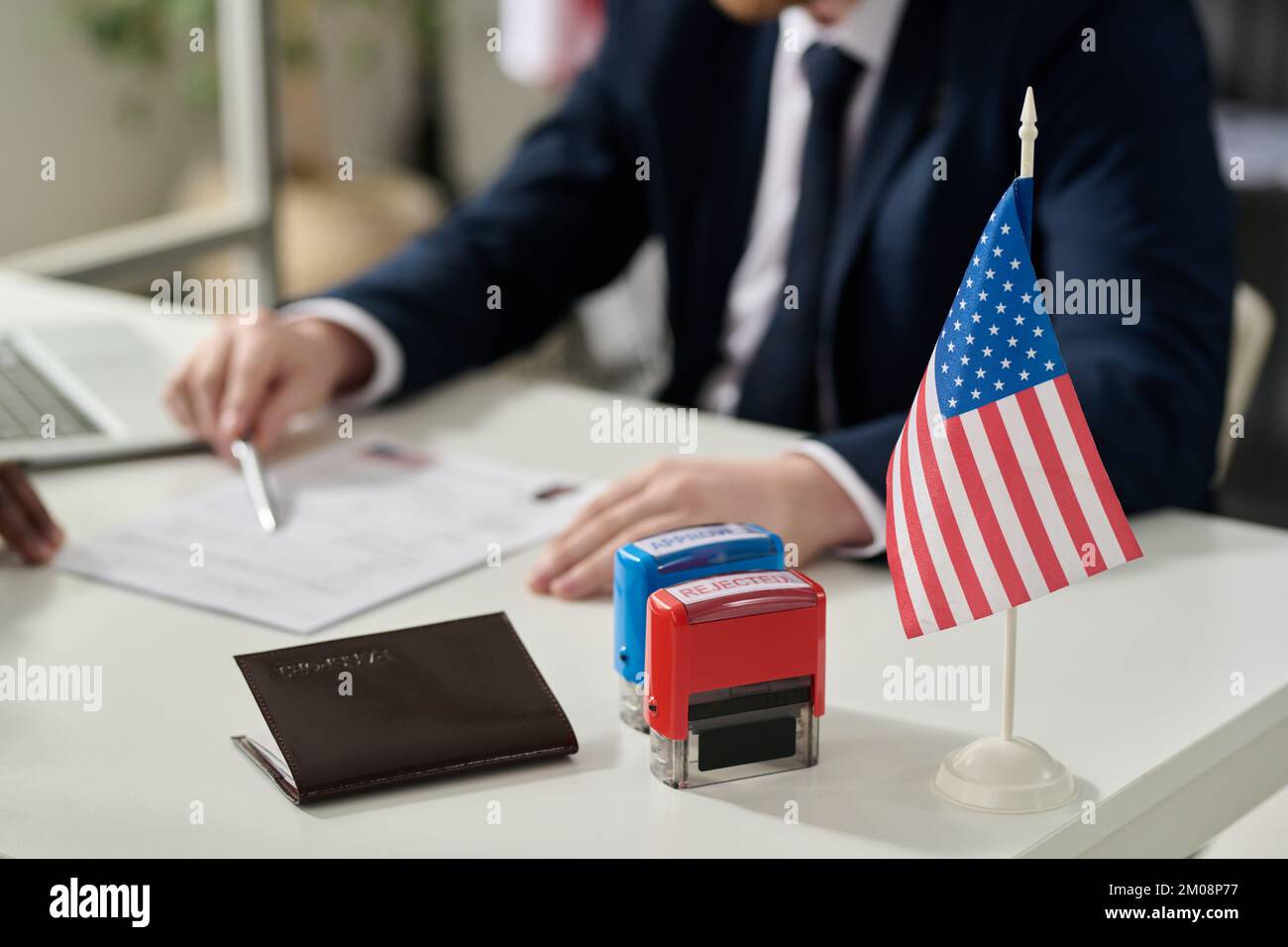 Close up of approved and rejected stamps on table in US immigration office with flag, copy space Stock Photo
