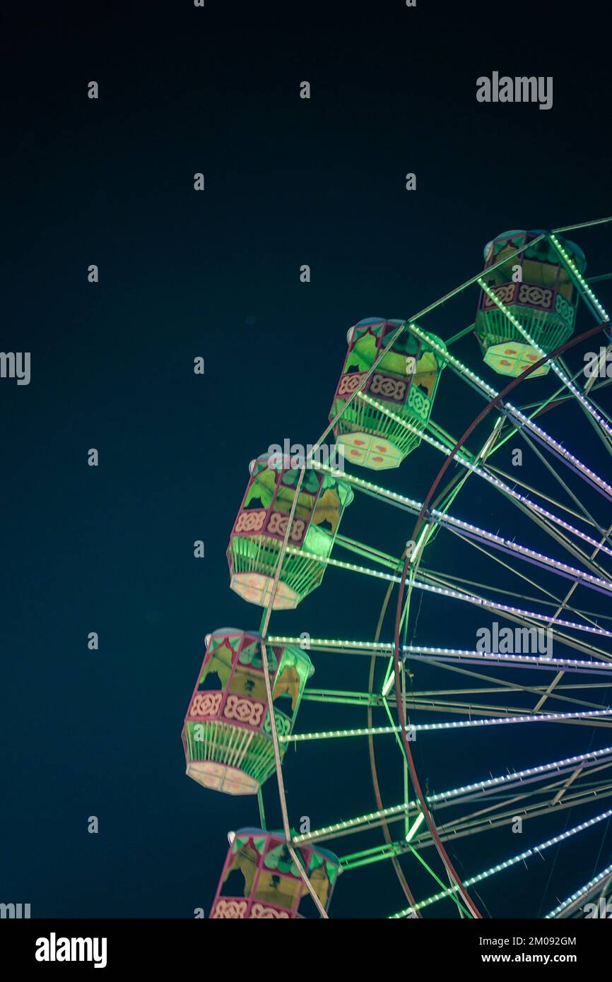 Giant ferris wheel with green lighting in An Exhibition indian Fair at ...