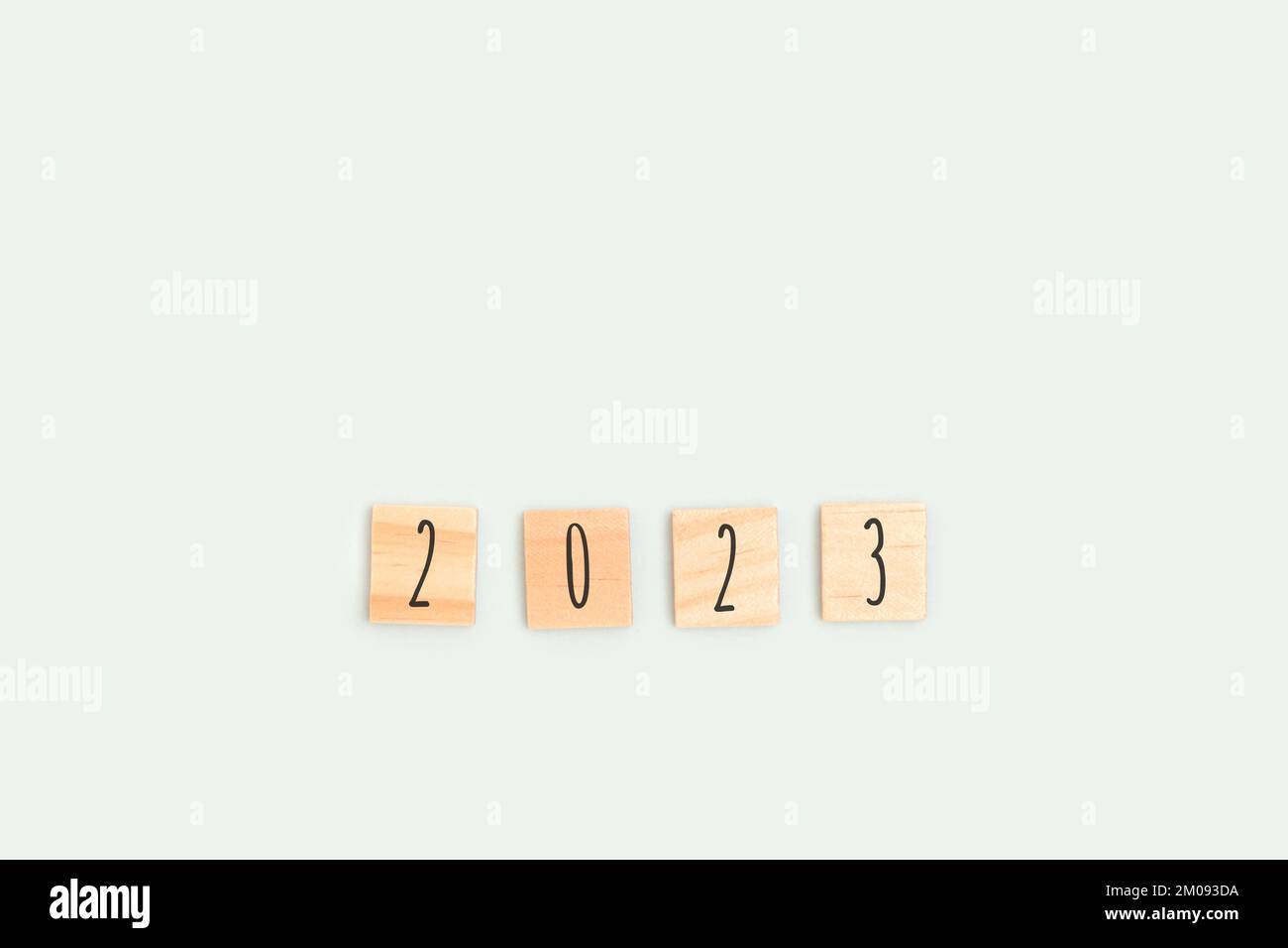 Number 2023. Wooden blocks with letters on a blue pastel background. New Years minimal concept. Stock Photo