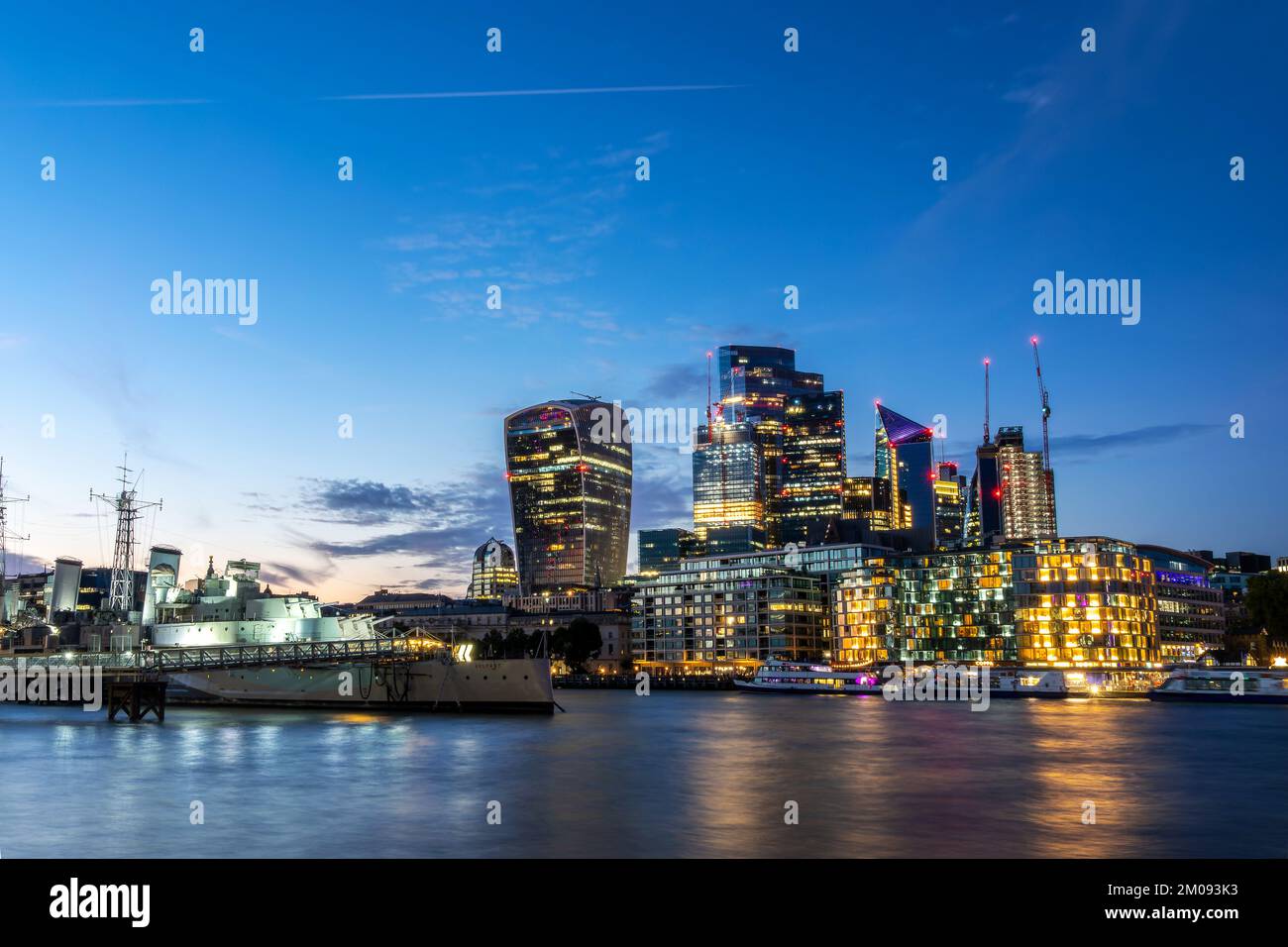 HMS Belfast war ship and the City at night, in London, UK Stock Photo