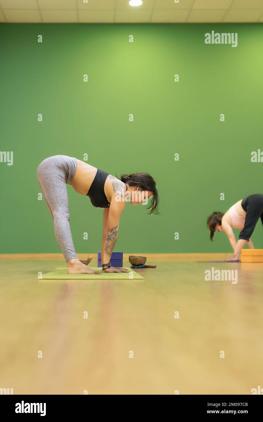 Vertical Photo Of Young Yoga Teacher Teaching Yoga Classes With The Prasarita Padottanasana A 