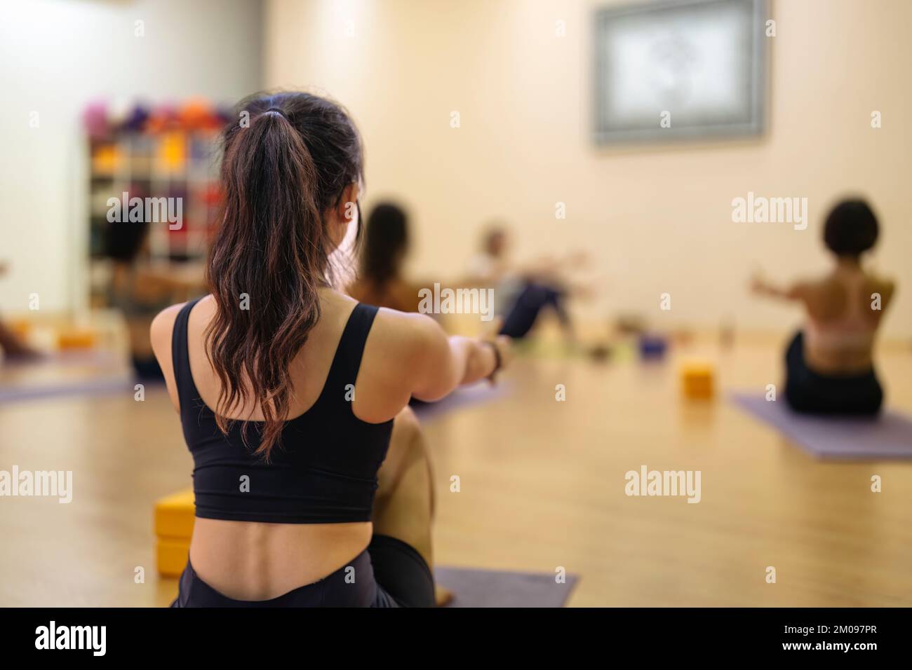 young asian girl doing yoga together with other people Stock Photo - Alamy