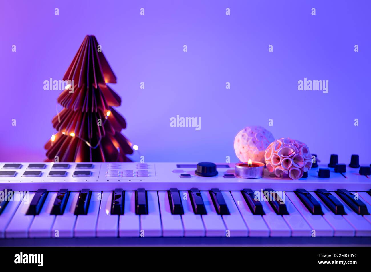 Christmas background with midi keyboard and holiday decor with neon