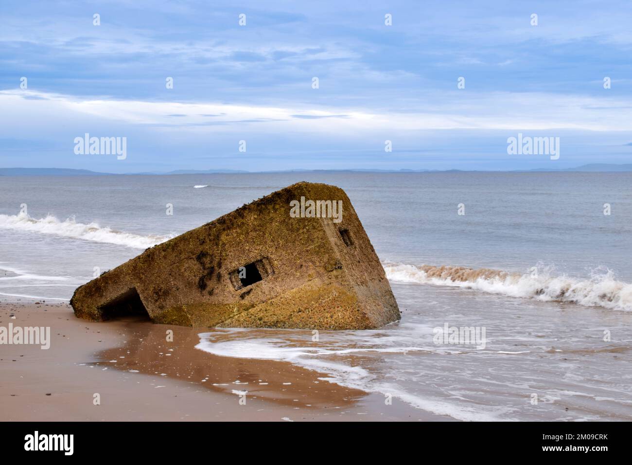 Findhorn Beach Moray Coast Scotland a World War 2 concrete pill box disappearing into the sands and sea Stock Photo