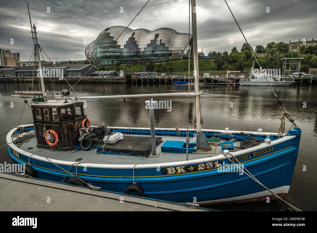 Trawler on Tyne in Newcastle with Sage Centre Behind Stock Photo