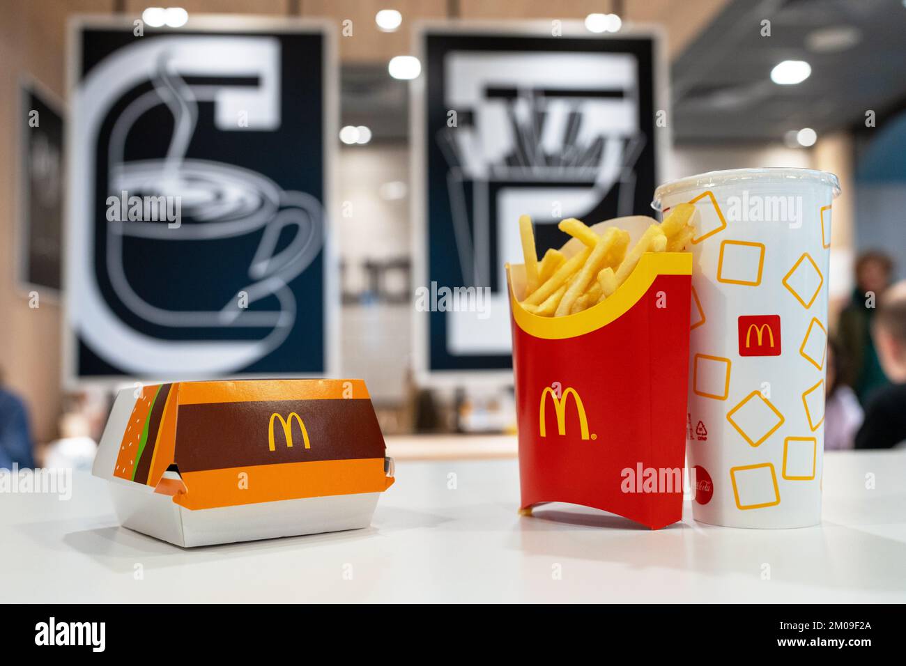 Big Mac Box with McDonald's logo, French Fries and soft drink in McDonald's Restaurant. Stock Photo