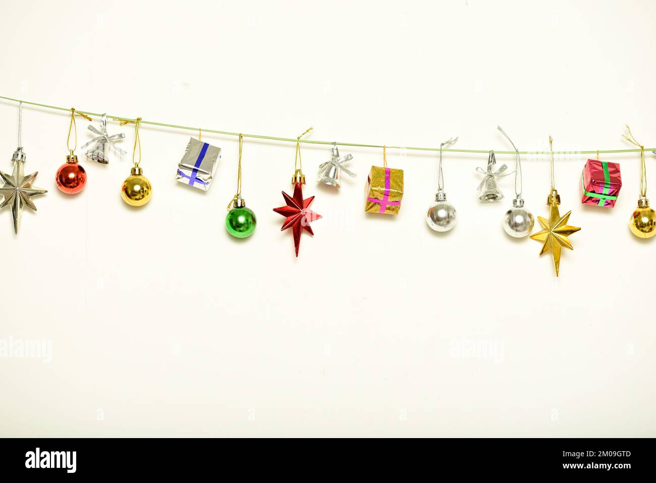 Christmas gifts are hanging on isolated white background Stock Photo