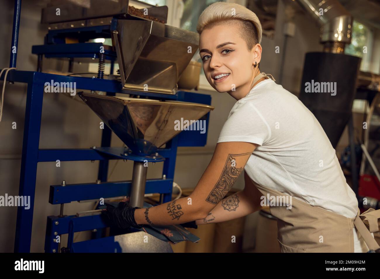 Joyous roast master working at the coffee roastery Stock Photo Alamy