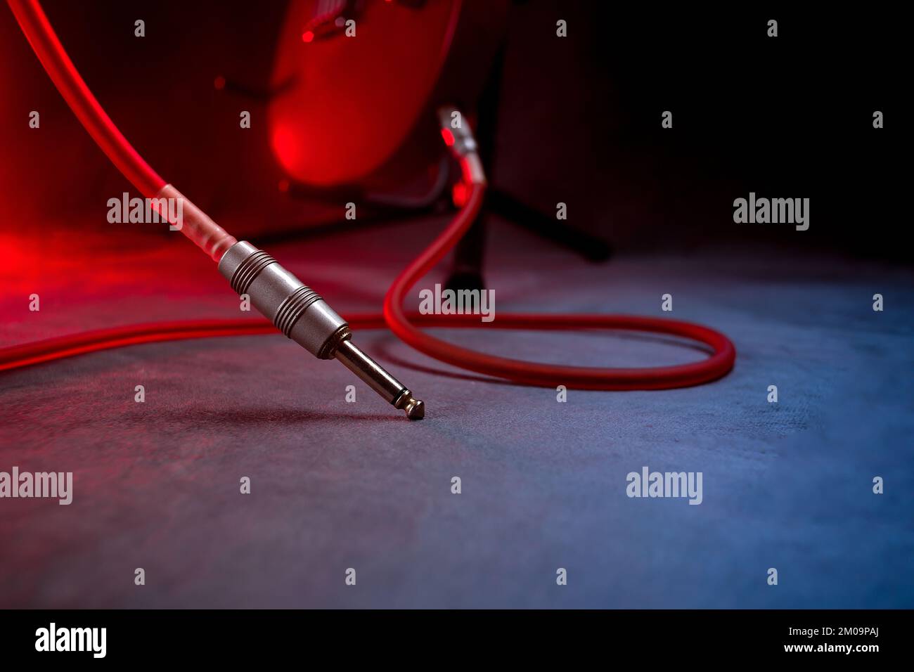 guitar pulled from the ground on the stage and the jack cable connected