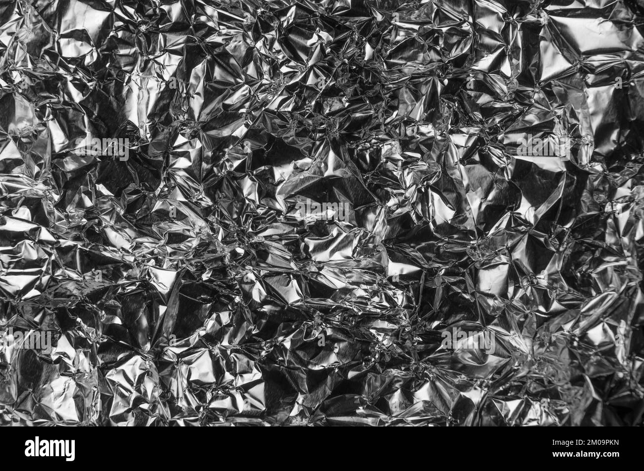 Silver metallic crumpled aluminum foil background Stock Photo