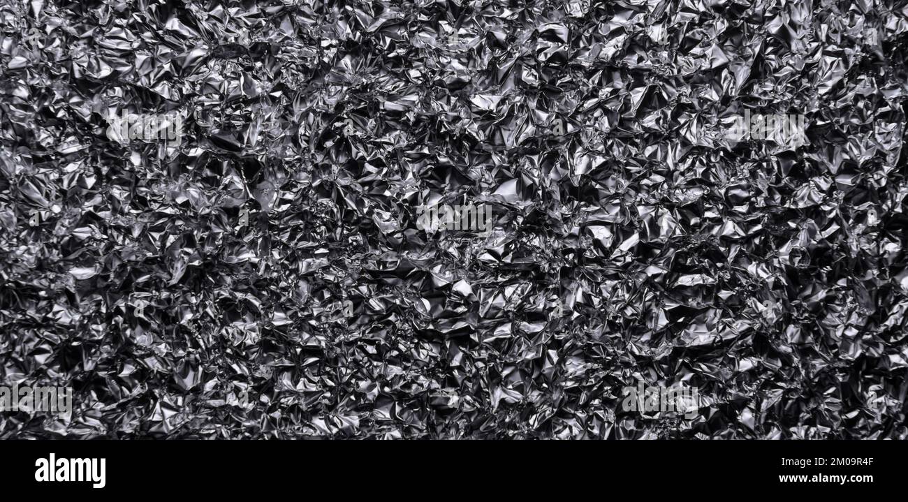 Silver metallic crumpled aluminum foil background Stock Photo