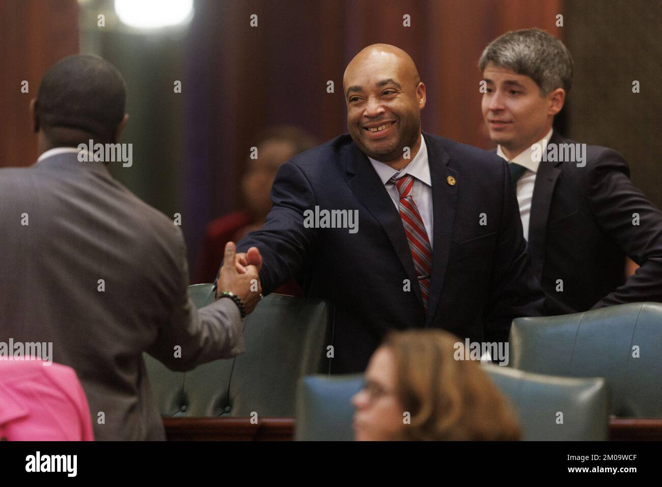 State Rep. Justin Slaughter celebrates after the chamber passed changes