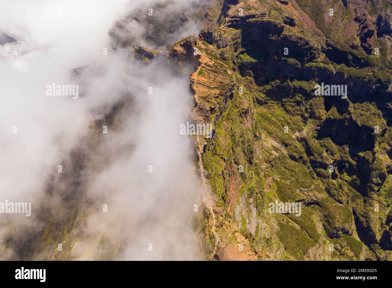 Drone view of mountain trail path submerged in fog during summer Stock Photo - Alamy