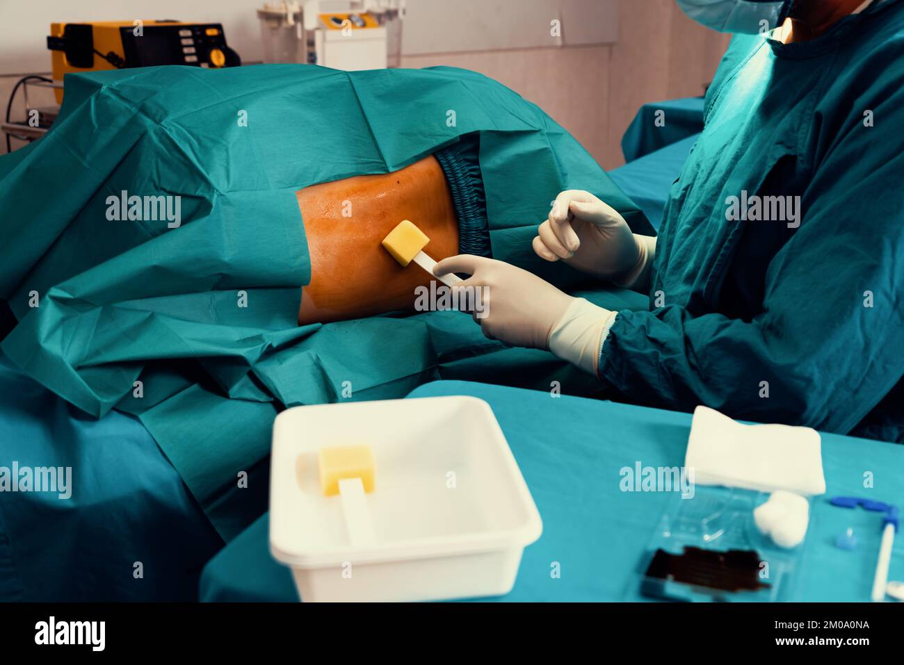 Doctor or surgeon apply betadine to the patient for anesthesia