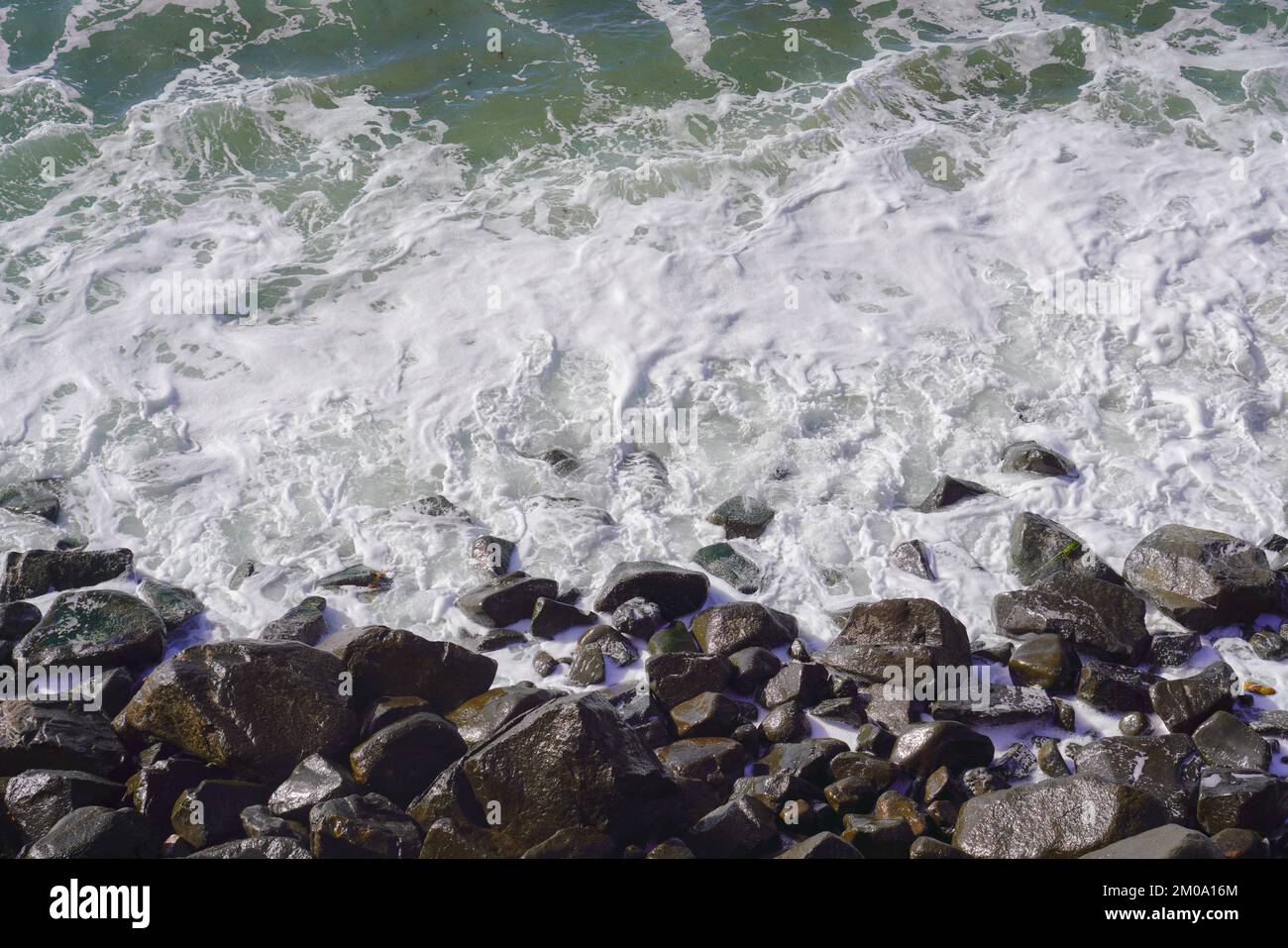 Ocean Rocks Soft The soft ocean waves with foam crashing on rocks in San Diego ...