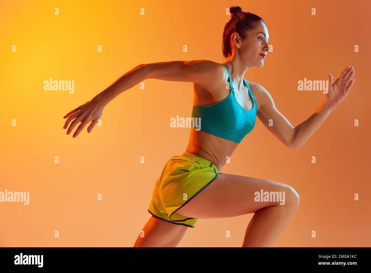 Athlete in motion. Young fitness sportive girl in sports uniform