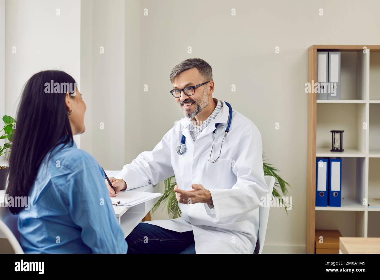 Doctor and patient and consultation hi-res stock photography and images ...