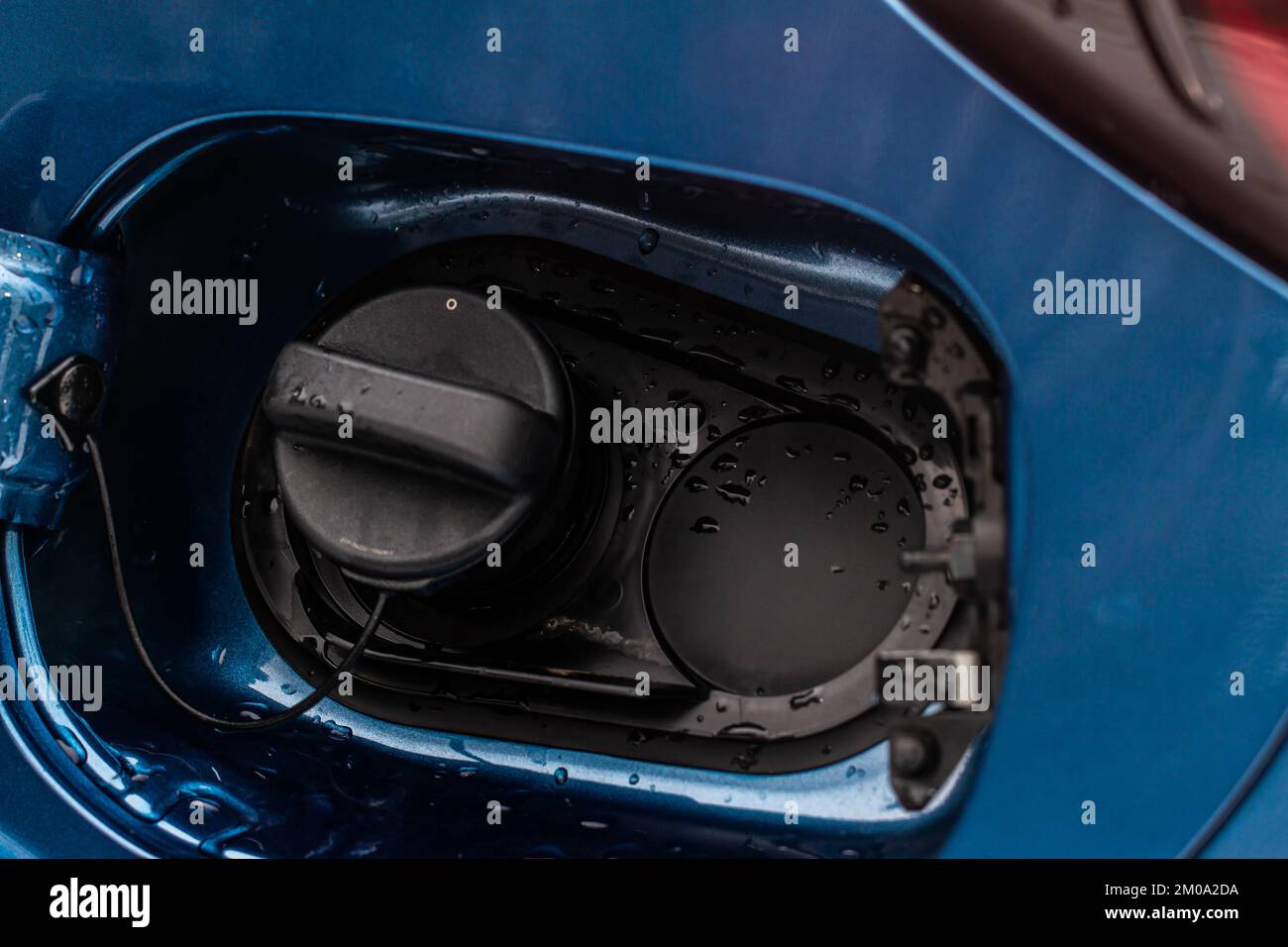 Exterior of car with fuel filler door open. Opened fuel tank cap of a