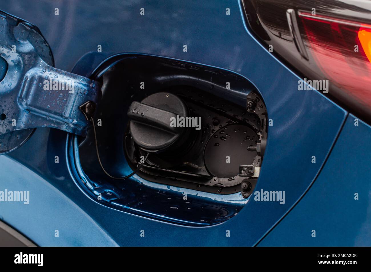 Exterior of car with fuel filler door open. Opened fuel tank cap of a car for filling gasoline