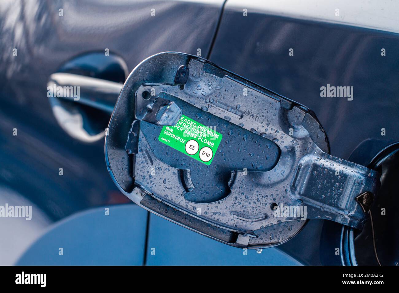 Exterior of car with fuel filler door open. Opened fuel tank cap of a