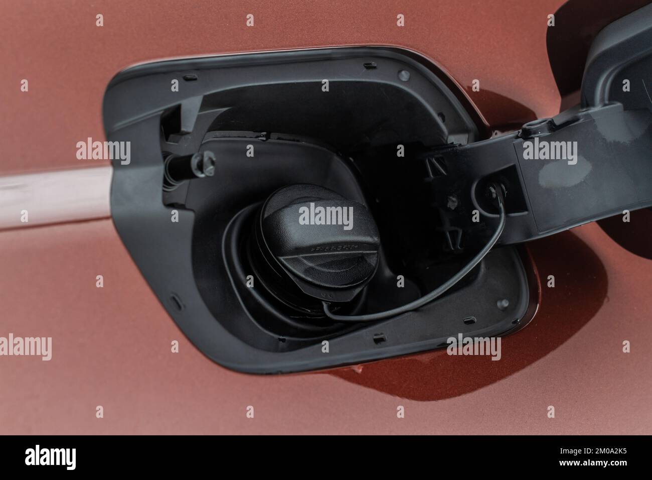 Exterior of car with fuel filler door open. Opened fuel tank cap of a car for filling gasoline