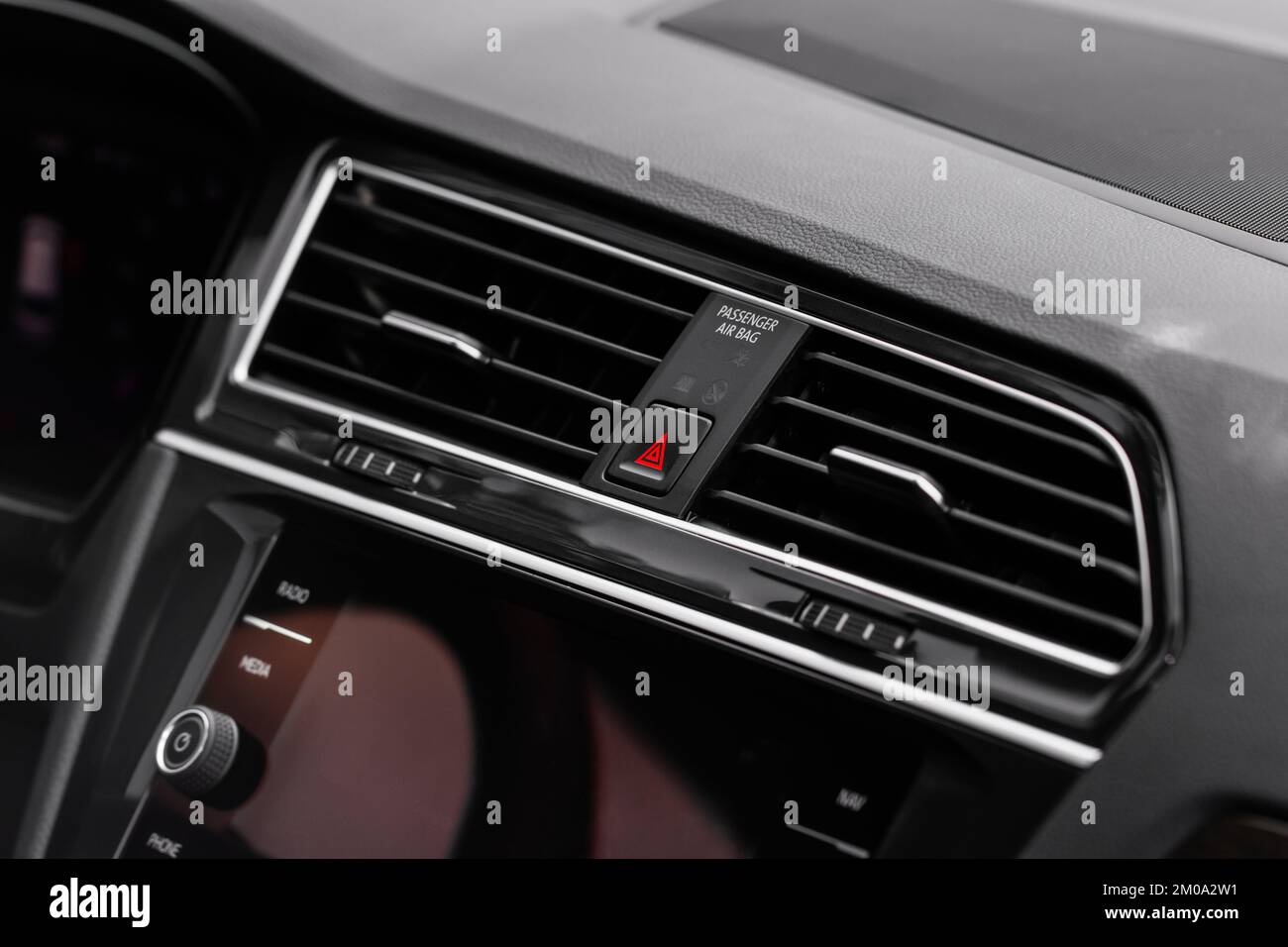 Red triangle hazard light button on car dashboard. Car media buttons