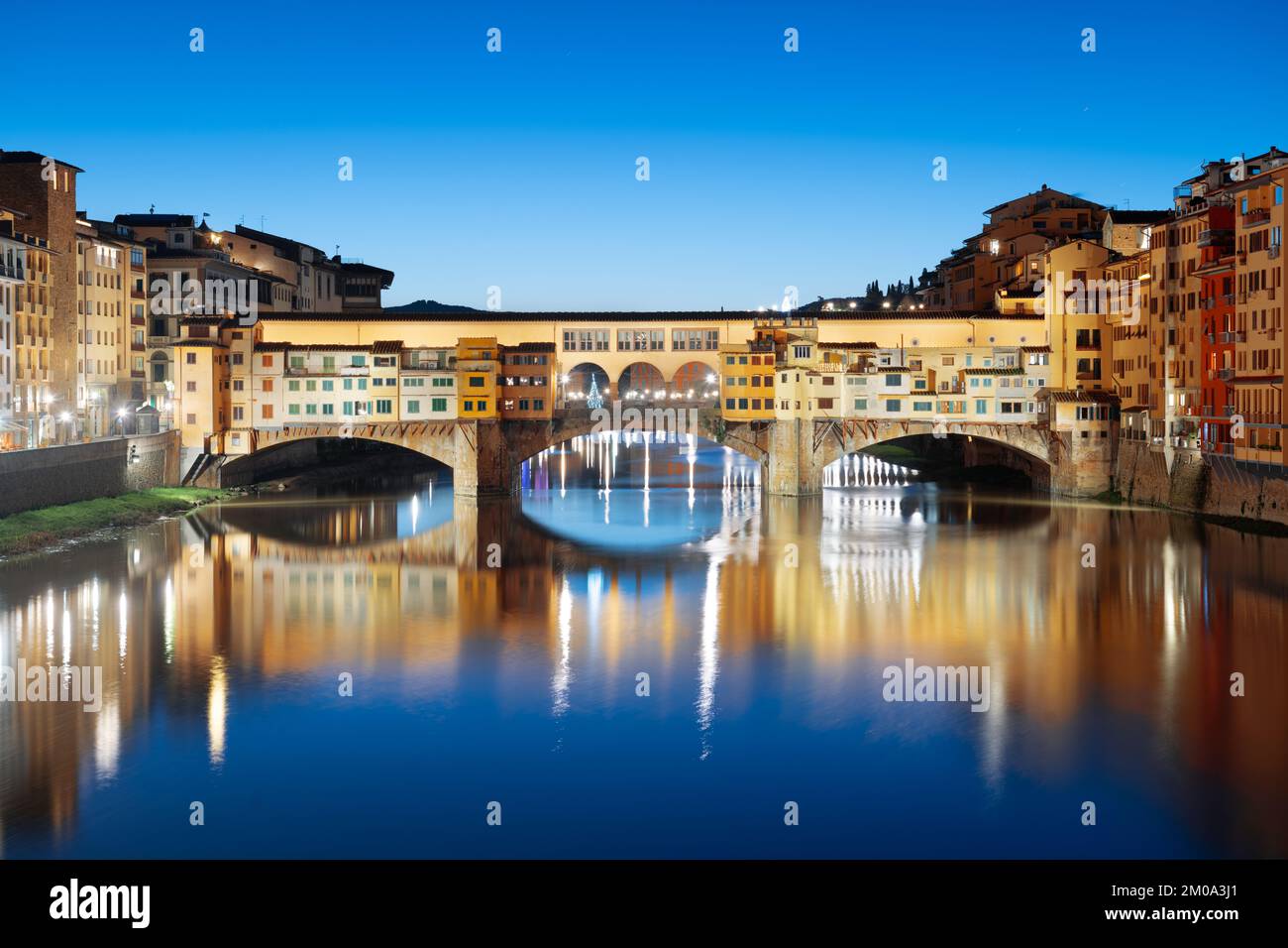 Florence, Italy at the Ponte Vecchio Bridge crossing the Arno River at twilight. Stock Photo