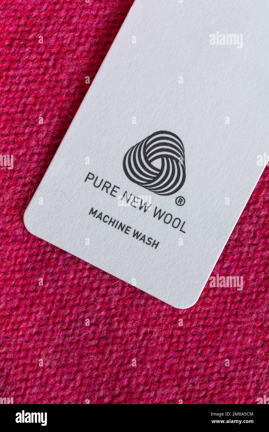 Pure New Wool logo in woman's pink jumper - machine wash Stock Photo