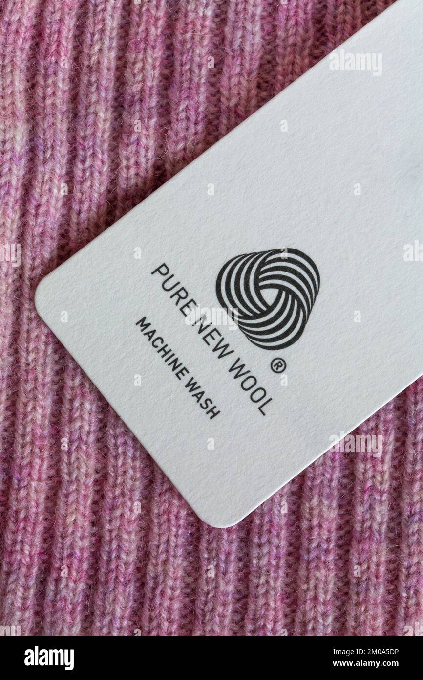 Pure New Wool logo in woman's pink jumper - machine wash Stock Photo