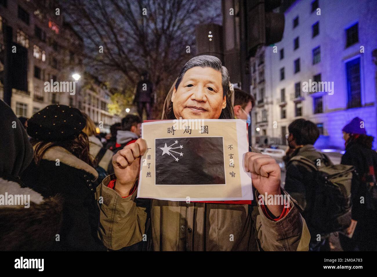 London, UK. 05th Dec, 2022. A protester wears a mask of Xi Jinping while holding a poster during the demonstration outside the Chinese Embassy in London. Chinese students who are currently studying in London gathered at the Chinese Embassy in London to protest against the lockdown policy in China. A massive wave of protests outbroke in China last week since 10 people were killed in a Urumqi in the Northwest region of China due to the inhumane COVID lockdown policy. (Photo by Hesther Ng/SOPA Images/Sipa USA) Credit: Sipa USA/Alamy Live News Stock Photo