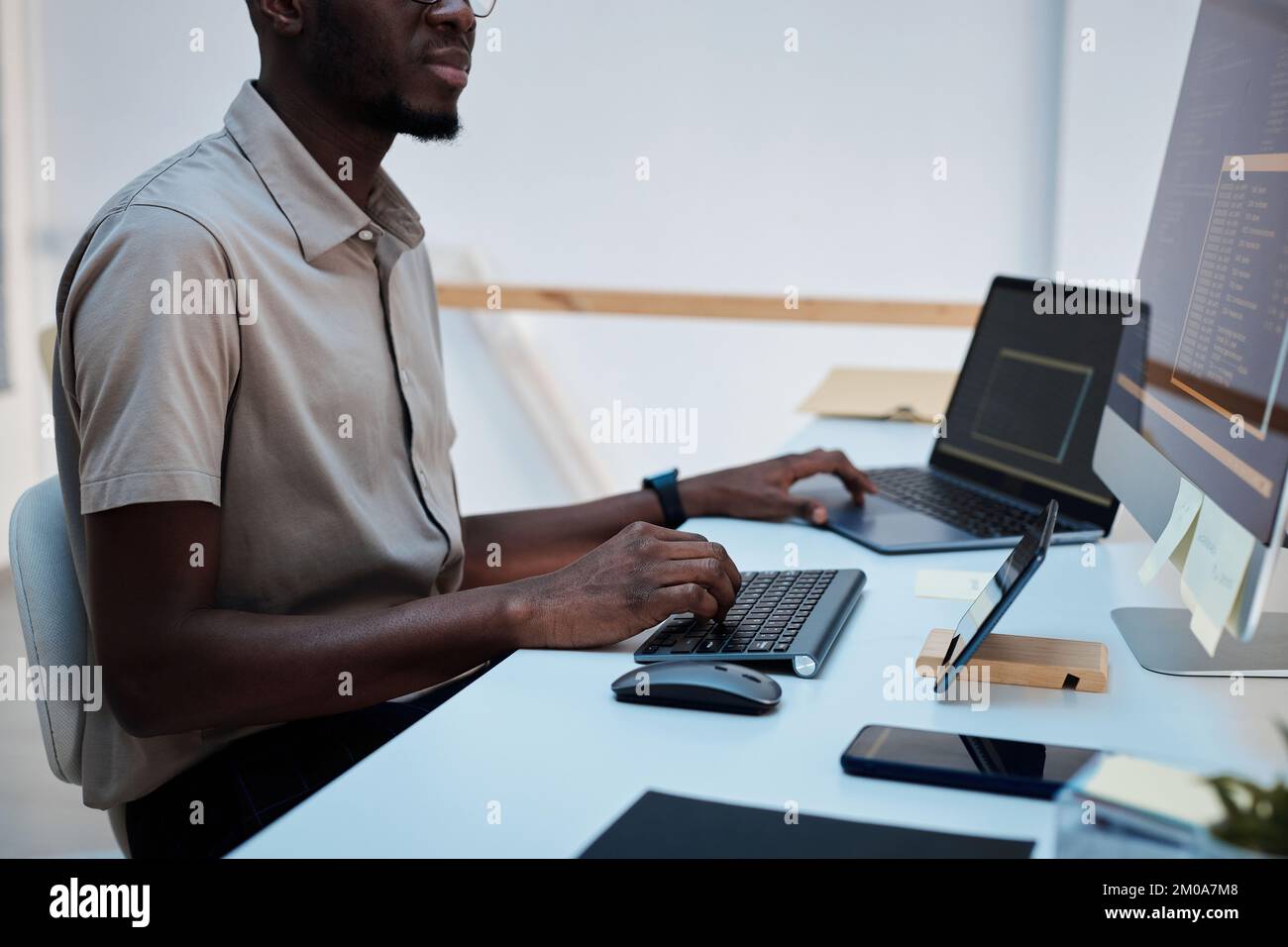 Cropped image of developer writing programming code to automate process Stock Photo