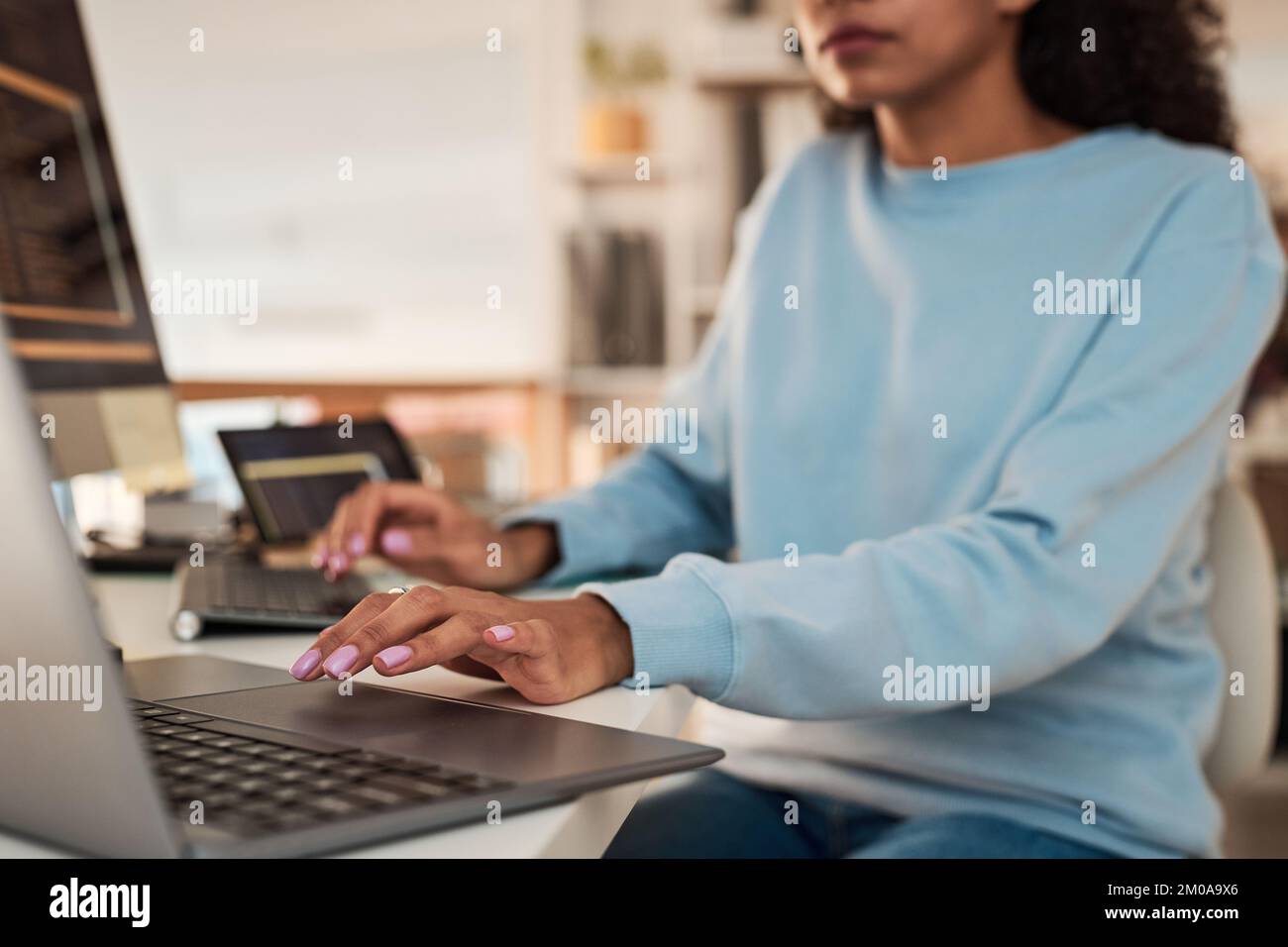 Cropped image of software developer working on laptop in modern office Stock Photo