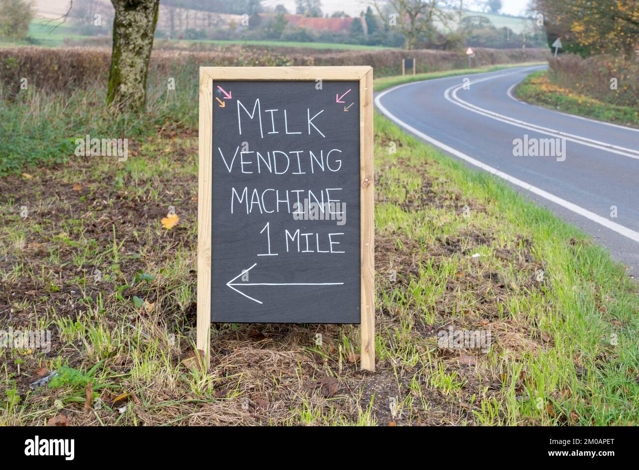 Sign for a Milk Vending Machine, organic milk being sold directly to customers on a dairy farm, West Sussex, England, UK Stock Photo