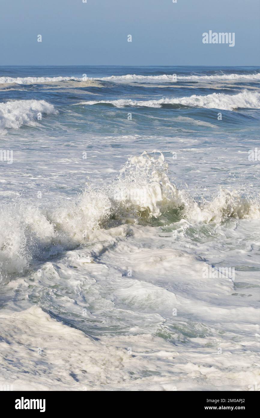 Foamy turbulent water on the Pacific Ocean during a king tide in
