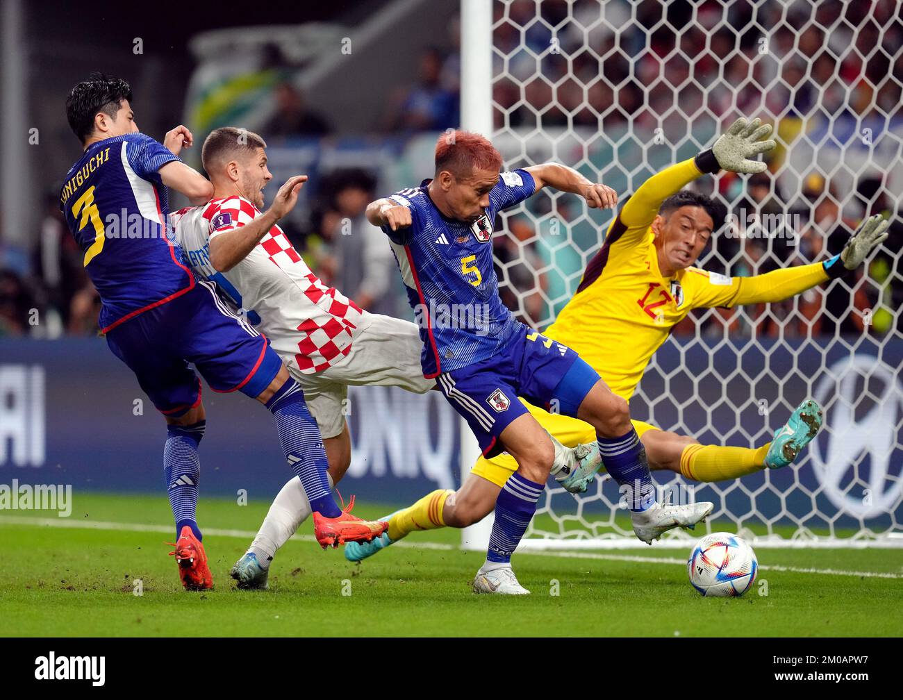 Croatia's Andrej Kramaric is denied a goal scoring chance as he is crowded out by Japan’s Shogo Taniguchi, Yuto Nagatomo and goalkeeper Shuichi Gonda during the FIFA World Cup Round of Sixteen match at the Al Janoub Stadium in Al-Wakrah, Qatar. Picture date: Monday December 5, 2022. Stock Photo